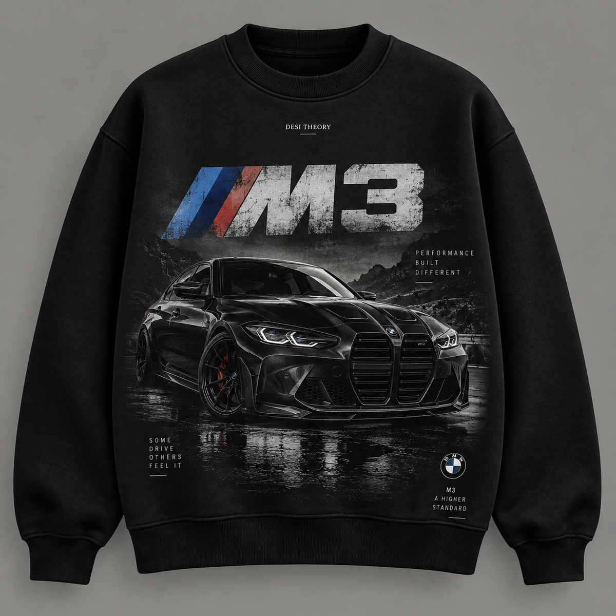 A black crewneck sweatshirt featuring a large graphic print of a black BMW M3 car on a wet road, with the 'M3' logo and 'Dial Theory' branding printed on the front.